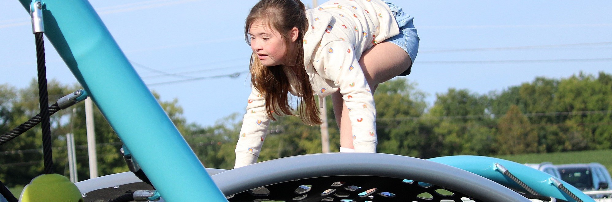 Girl climbs on playground